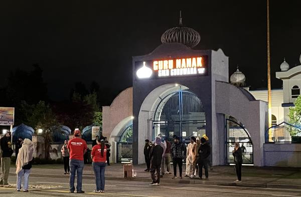 Mourners outside Guru Nanak temple early Mo<em></em>nday after temple president Hardeep Nijjar was shot to death hours earlier